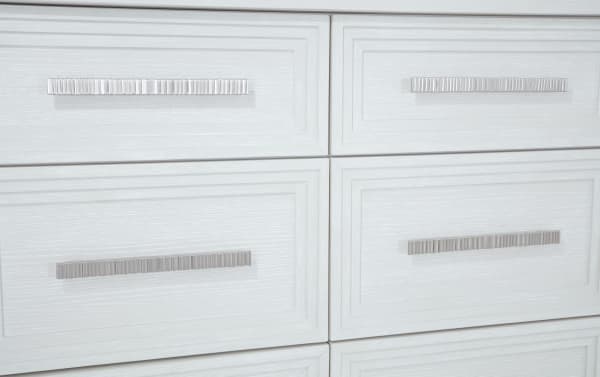 Contemporary Infinity White 9 Drawer Dresser in MDF with sleek silver ribbed handles, part of the Infinity Bedroom collection, featuring a clean white wood grain finish.