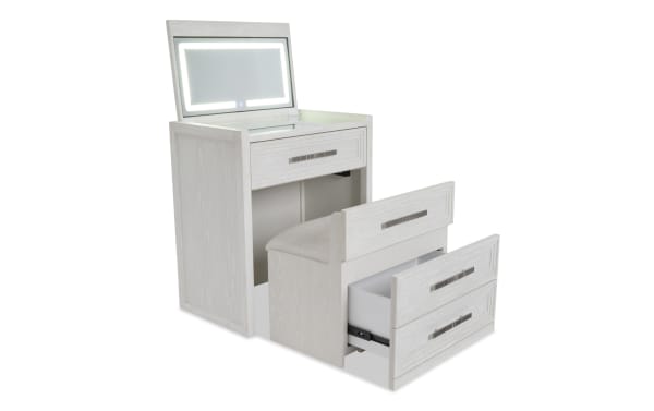 White wooden vanity set with LED-lit mirror, cushioned stool, and multiple drawers for storage, ideal for bedroom or dressing room.