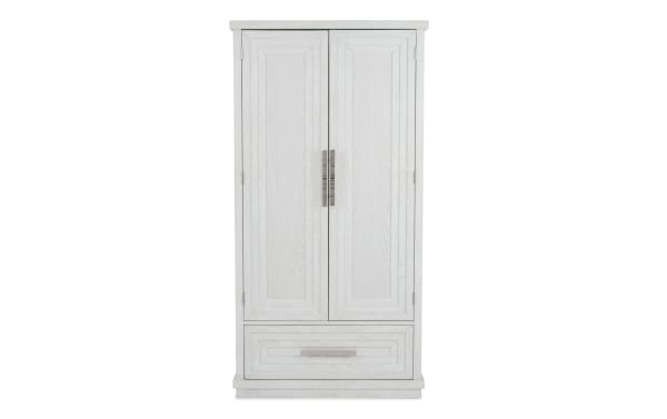 White wooden wardrobe with two paneled doors and a large bottom drawer, featuring silver vertical handles and a classic design.