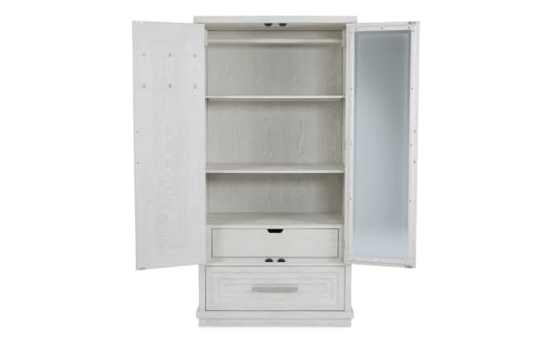 White wooden wardrobe with two open doors, featuring multiple shelves, a hanging rod, two drawers, and a full-length mirror on the right door.