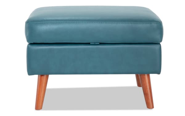Teal Bettie Storage Ottoman in mid-century modern style with faux leather upholstery, wooden legs, and cushioned memory foam top with hidden storage.
