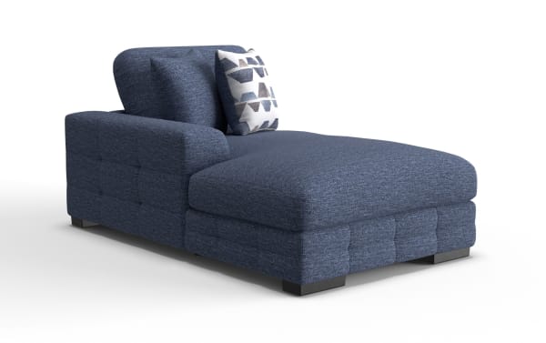 Modern navy blue fabric chaise lounge with tufted upholstery, cushioned backrest, and decorative geometric-patterned pillow, ideal for living room seating.