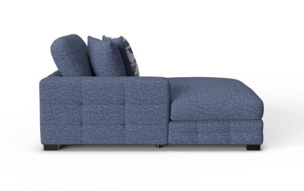 Modern blue fabric sectional sofa with chaise lounge, tufted cushions, and low black wooden legs, ideal for contemporary living rooms.