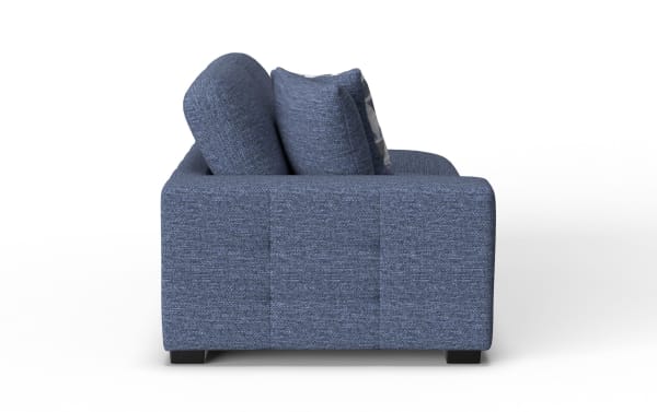 Blue fabric sofa with cushioned armrest and backrest, featuring two matching blue pillows and a modern, low-profile design.