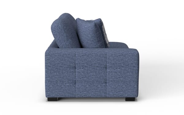Blue fabric sofa with thick cushions and a modern, boxy design shown from the side, highlighting its textured upholstery and sturdy black feet.