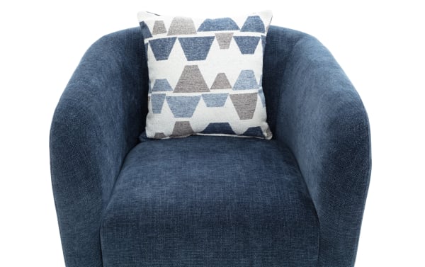 Blue upholstered barrel chair with curved arms, textured fabric, and a decorative geometric-patterned throw pillow.