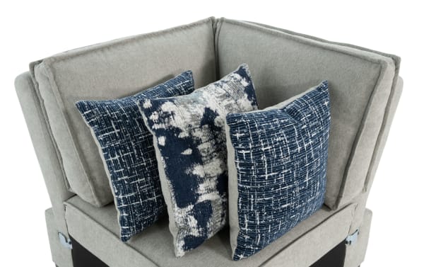 Gray Playmax Corner sectional with plush polyester upholstery, transitional style, and three blue patterned accent pillows for added comfort.