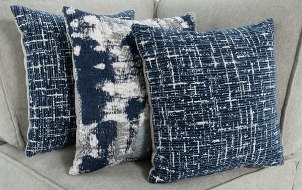 Gray polyester fabric accent pillows with blue and white abstract patterns on the Playmax Gray Corner transitional sofa.