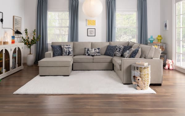Transitional Playmax gray right arm facing storage chaise sectional sofa with polyester fabric upholstery, Bob-O-Pedic memory foam seating, built-in USB/USB-C ports, hidden storage, and patterned accent pillows.
