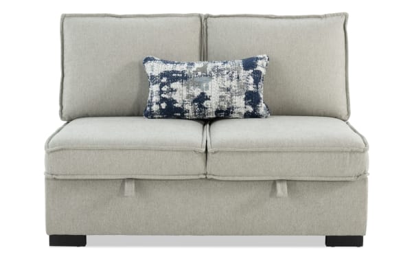 Playmax Gray Armless Storage Loveseat in gray polyester fabric with Bob-O-Pedic memory foam seating, hidden storage, and a blue patterned accent pillow.