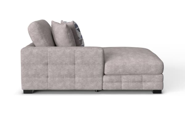 Modern light gray fabric sectional sofa with plush cushions and a chaise lounge, featuring a textured upholstery and low black legs.