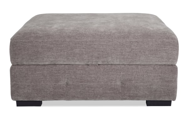 Contemporary Playground Gray Storage Ottoman with plush textured gray polyester fabric, memory foam seating, hand-tufted detailing, and hidden storage.