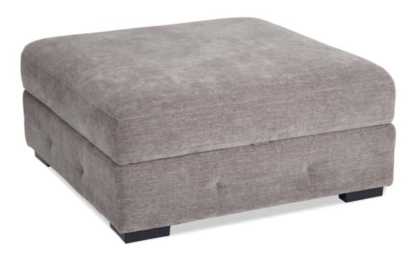 Contemporary Playground Gray Storage Ottoman with plush gray polyester fabric, hand-tufted detailing, memory foam seating, and hidden storage.