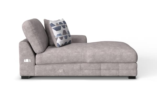 Modern chaise lounge upholstered in light gray textured fabric with two cushions, featuring a geometric patterned throw pillow and black wooden legs.