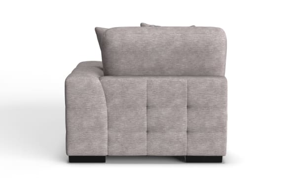 Gray fabric upholstered sofa with a tufted backrest, wide armrest, and black block legs, shown from the side.