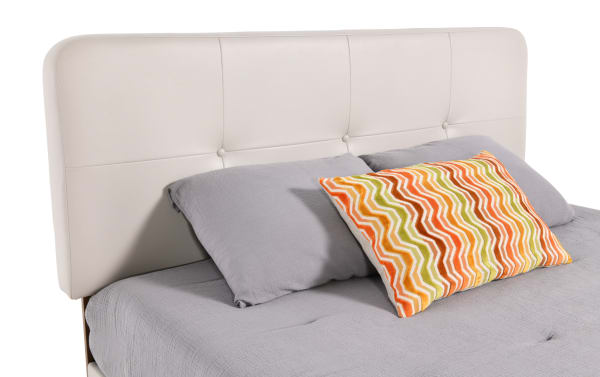 Cream faux leather upholstered platform bed from the Bettie Bedroom collection, featuring a mid-century modern tufted headboard with vinyl upholstery and tapered legs.