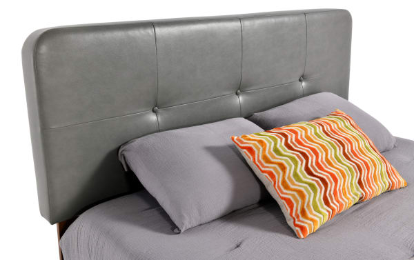 Charcoal gray Bettie Twin platform bed with mid-century modern style, tufted faux leather vinyl headboard, and tapered legs from Bettie Bedroom collection.