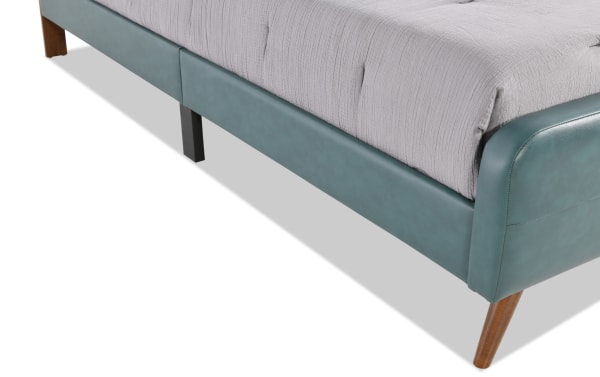 Teal faux leather upholstered platform bed from Bettie Bedroom collection, mid-century modern style with tapered wooden legs and vinyl upholstery.