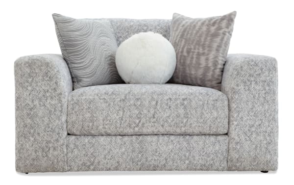 Modern gray fabric loveseat with a textured pattern, featuring wide armrests and three decorative plush throw pillows in varying gray and white tones.