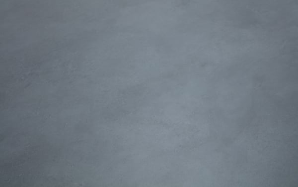 Smooth, matte gray concrete floor surface with subtle texture and slight variations in shading, suitable for industrial or modern interior design.