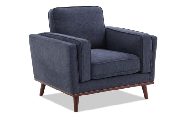 Tribeca Navy Chair in mid-century modern style with navy polyester fabric upholstery, memory foam cushion, and wooden tapered legs.