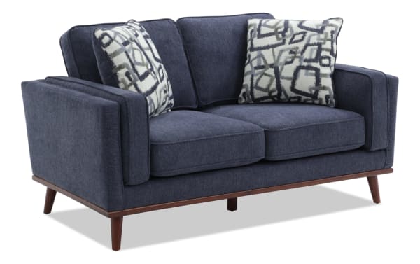 Tribeca Navy 66'' Loveseat in blue polyester fabric with mid-century modern design, tapered wooden legs, memory foam cushions, and patterned accent pillows.