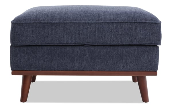Tribeca Navy Storage Ottoman in mid-century modern style with navy polyester fabric upholstery, memory foam cushion, and hidden storage compartment.