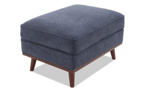 Tribeca Navy Storage Ottoman in mid-century modern style with navy polyester fabric upholstery, memory foam cushion, and hidden storage space.