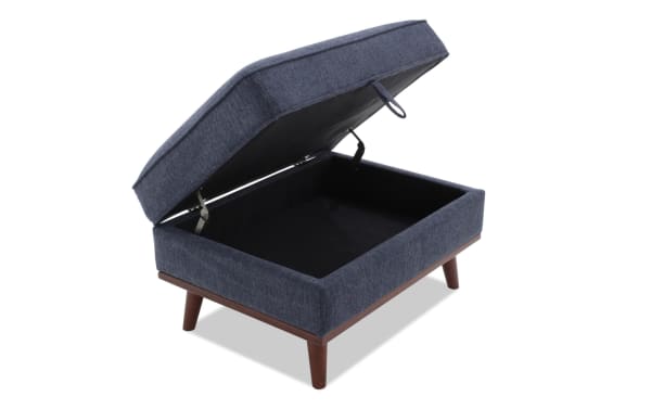 Tribeca Navy Storage Ottoman in mid-century modern style, upholstered in navy polyester fabric with memory foam cushion and hidden storage compartment.