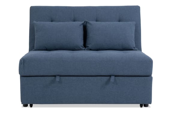 Chadwick Denim Futon in blue polyester fabric with transitional style, featuring a tufted backrest, two matching cushions, and compact design ideal for lounging and guest sleeping.