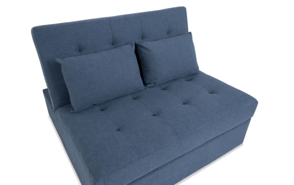 Chadwick Denim Futon in blue polyester fabric with tufted transitional design, featuring adjustable backrest for lounge or bed mode.