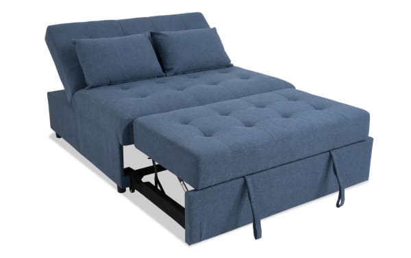 Chadwick Denim Futon in blue polyester fabric with tufted cushions, transitional style, fold-down backrest, and pull-out seat for quick guest bed conversion.