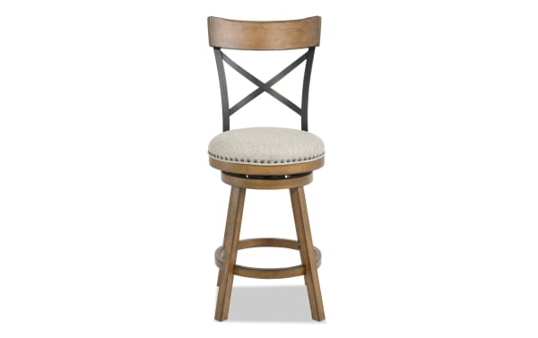 Transitional Iris Dining swivel stool with beige polyester fabric seat, brown rubberwood frame, adjustable height, cross-back design, and nailhead trim.