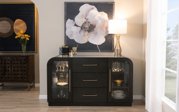 Luxe Dining contemporary server with brown and beige marble top, rounded edges, three dark wood drawers, tempered glass doors, and gold hardware.