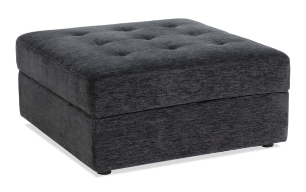 Contemporary Modular Bob® Charcoal Storage Ottoman in gray polyester fabric with tufted top, memory foam cushion, and hidden storage space.