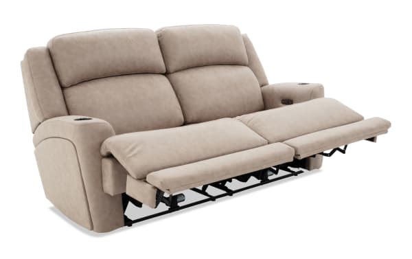 Beige microfiber reclining loveseat with plush cushioning, cup holders, and adjustable footrests for enhanced comfort and relaxation.
