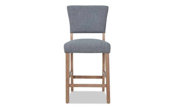 Transitional Elm Dining counter height stool with light gray polyester fabric upholstery, natural wood legs, and panel back design for kitchen or bar seating.