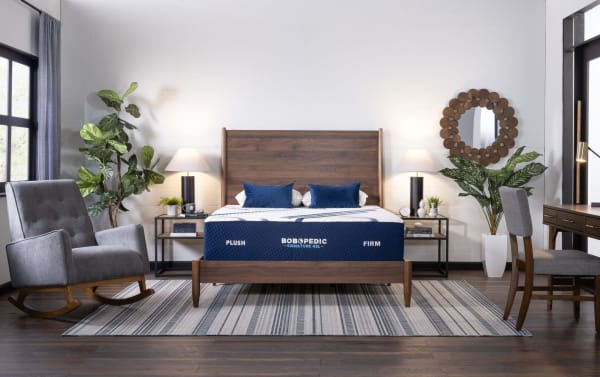 Bob-O-Pedic Signature Gel 13.5'' Twin XL Firm Mattress on mid-century modern wood bed frame with navy blue cover, plush and firm sides, in stylish bedroom setting.