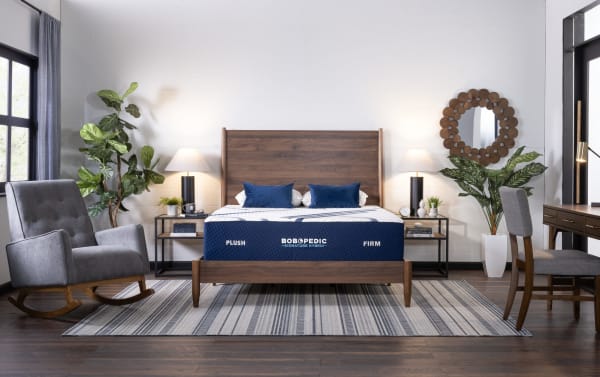 Queen-sized Bob-O-Pedic Signature Hybrid 13.5'' mattress in blue with plush and firm comfort options, set on a modern wood bed frame.