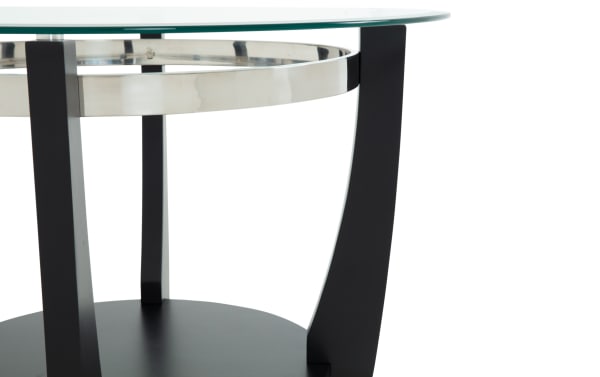 Modern round glass table with black metal legs and a stainless steel ring accent, showcasing a sleek contemporary design.