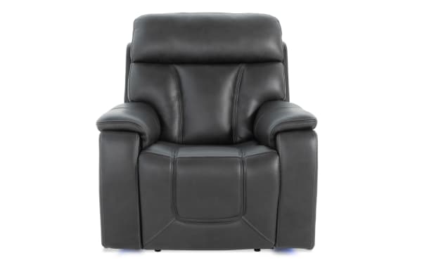 Black leather Showcase transitional power recliner with padded armrests, plush cushioning, and ergonomic design for immersive audio and comfort.