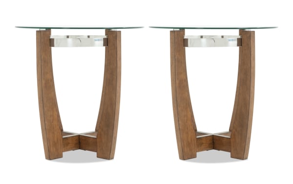 Pair of modern round side tables with clear glass tops, wooden curved legs, and silver metal accents, ideal for living room decor.