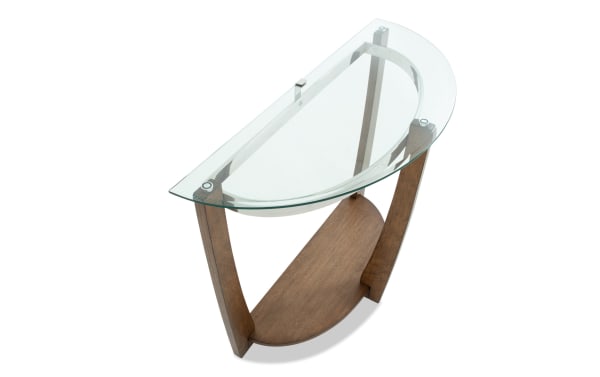 Modern half-moon console table with clear glass top and dark wood base, featuring a lower wood shelf for storage or display.