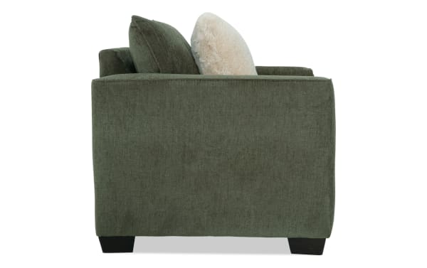 Brynn Green Chair side view showcasing soft green polyester fabric upholstery, plush memory foam cushioning, and transitional style from the Brynn collection.