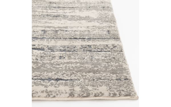 Dove 5' x 7' gray abstract rug with transitional style, made of soft polyester fabric featuring a neutral, textured pattern for versatile living spaces.