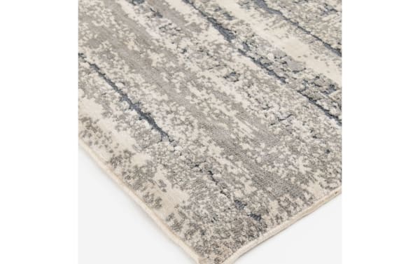 Transitional Dove 5' x 7' gray abstract rug with plush polyester fabric and memory foam infusion, featuring a neutral textured pattern.