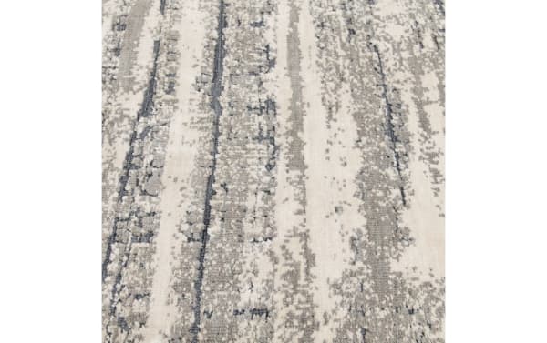 Gray abstract transitional Dove 5' x 7' rug with textured polyester fabric and memory foam infusion for soft, stylish living space flooring.