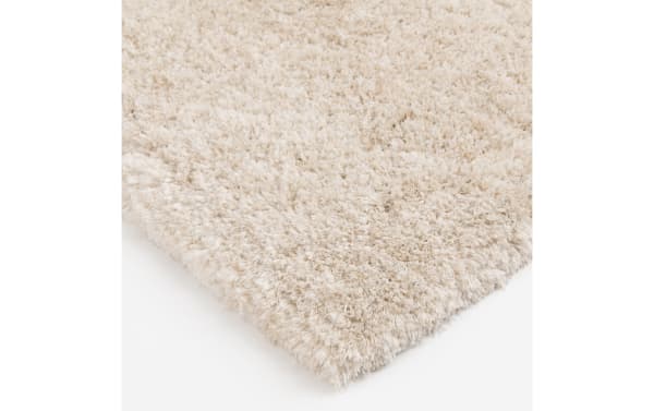 Sherpa 8' x 10' cream solid shag rug with ultra-plush polyester fabric and thick, soft pile in a transitional style for cozy flooring.