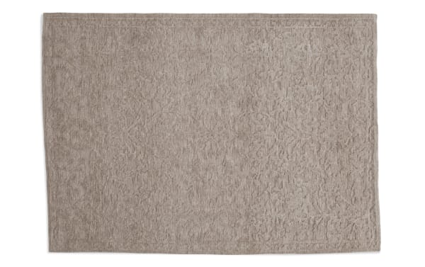 Taupe Alice 5' x 7' transitional area rug with subtle abstract floral pattern, made of soft polyester fabric with memory foam cushioning.