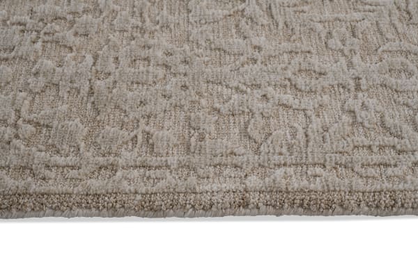 Taupe Alice 5' x 7' transitional area rug with abstract textured pattern, made of soft polyester fabric for plush, memory foam-like comfort.